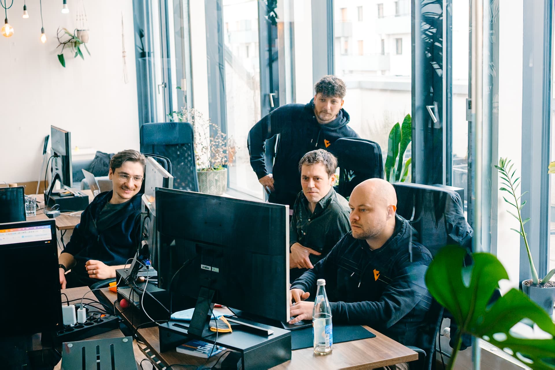 A team looking at a screen in the meeting room